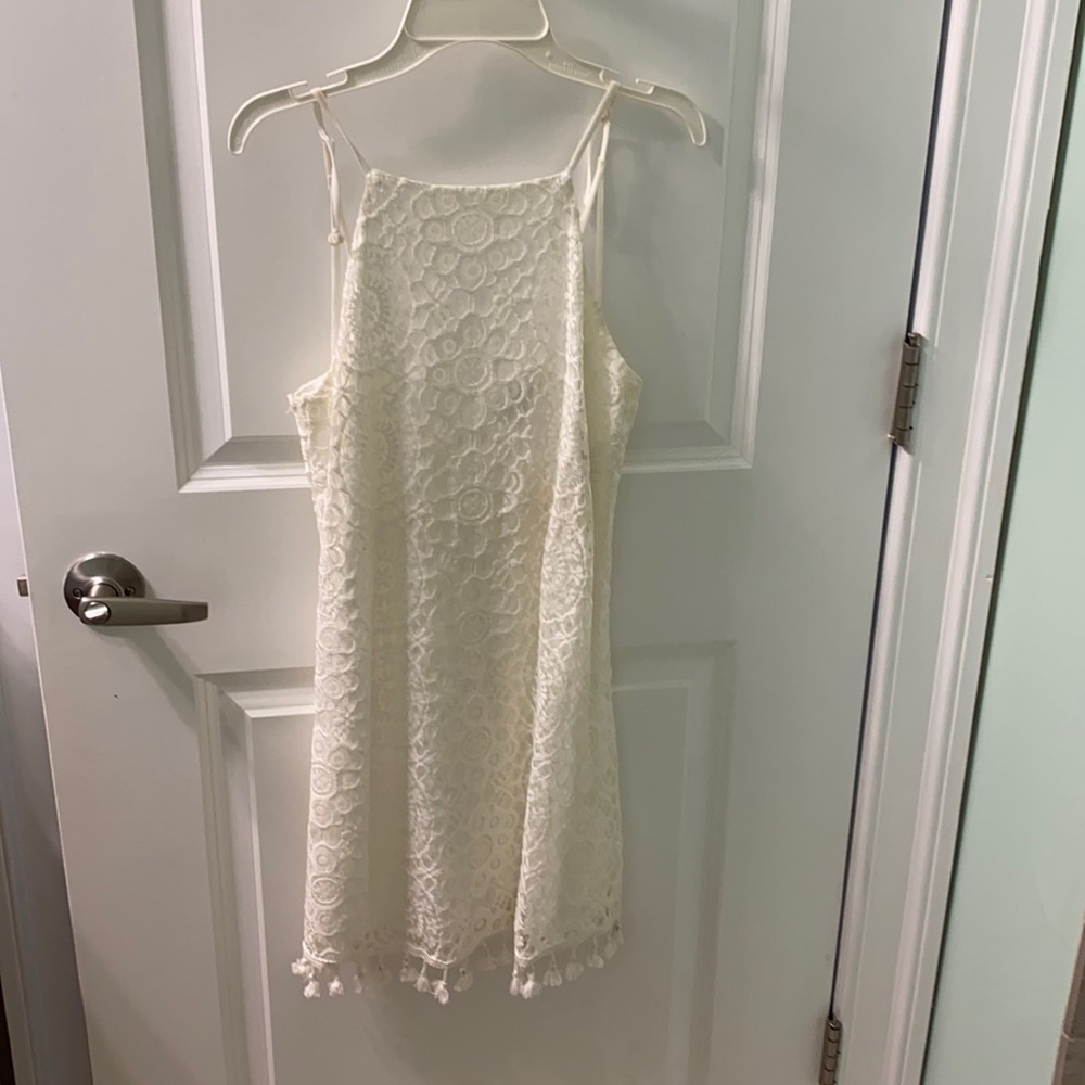 Size XS white lace mini dress with tasseled hems. Great condition.